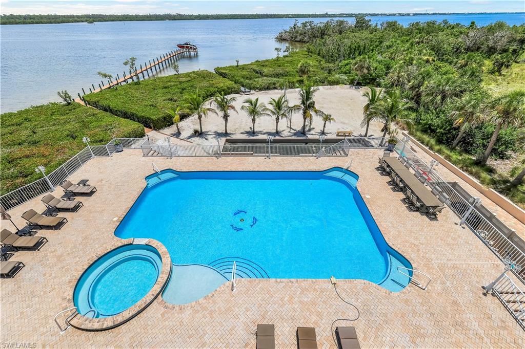 7159 Manasota Key Road Englewood, FL 34223 - Photo 41 of 50 View of swimming pool, hot tub with a patio area, bocce & Volleyball courts, and a view of Lemon Bay