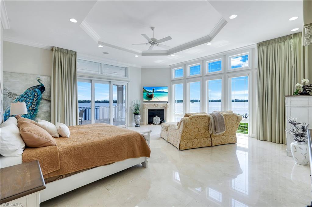 7159 Manasota Key Road Englewood, FL 34223 - Photo 7 of 50 a bedroom with a large bed and a large window