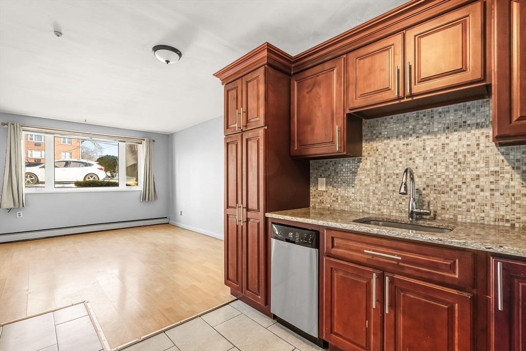 133 Warren Street, Unit 3 Watertown, MA 02472 - Photo 11 of 22 a view of kitchen with granite countertop appliances and cabinets
