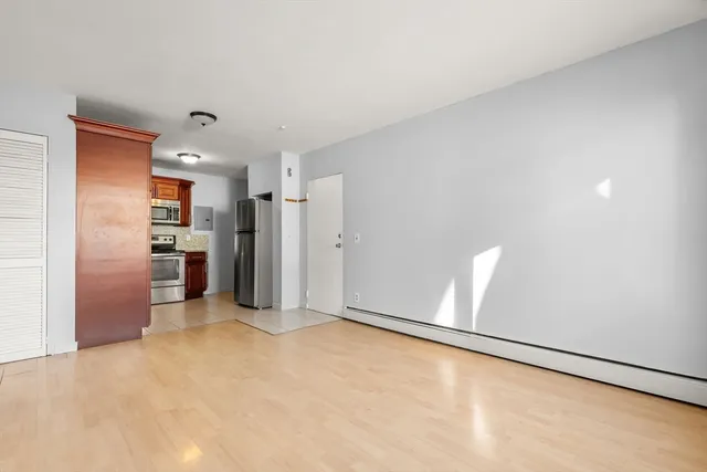 a view of a kitchen with refrigerator and a stove