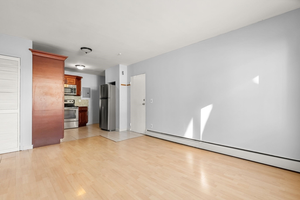 133 Warren Street, Unit 3 Watertown, MA 02472 - Photo 14 of 22 a view of a kitchen with refrigerator and a stove