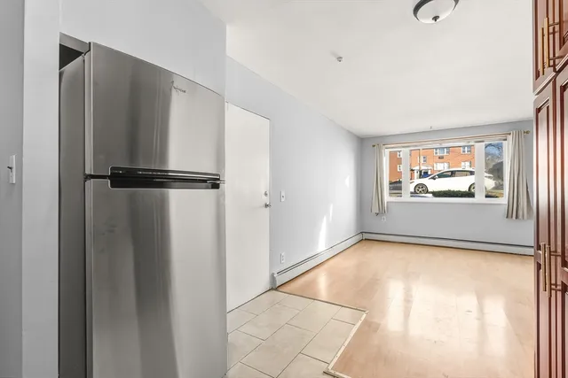 a view of a kitchen with a refrigerator and a window