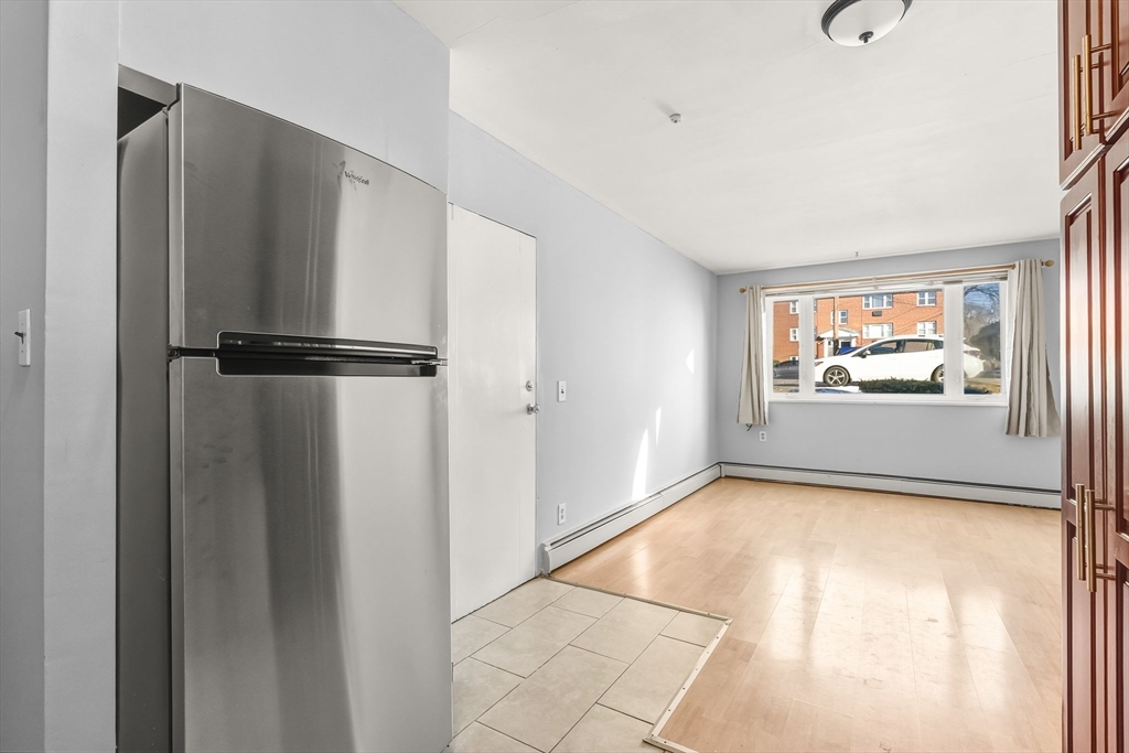 133 Warren Street, Unit 3 Watertown, MA 02472 - Photo 15 of 22 a view of a kitchen with a refrigerator and a window