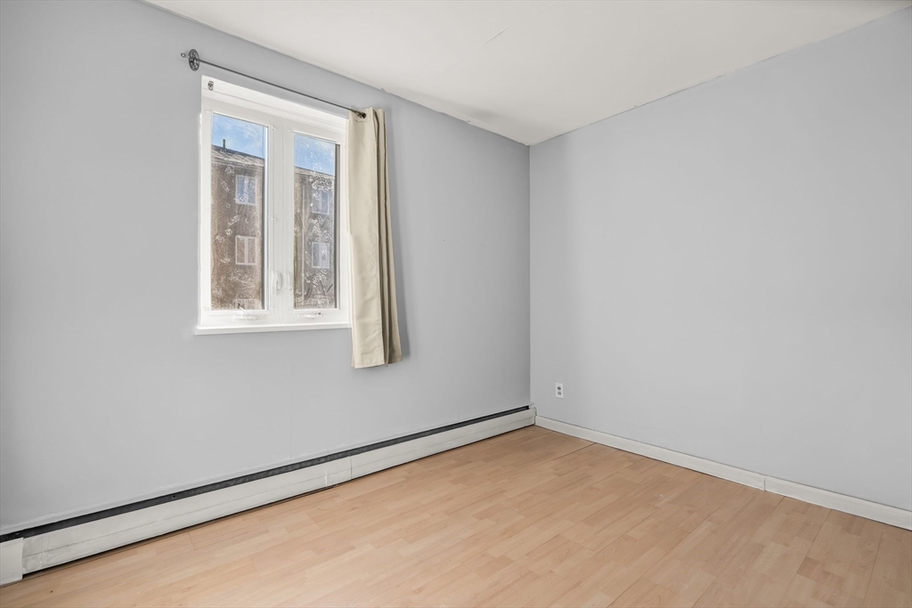133 Warren Street, Unit 3 Watertown, MA 02472 - Photo 18 of 22 an empty room with a window