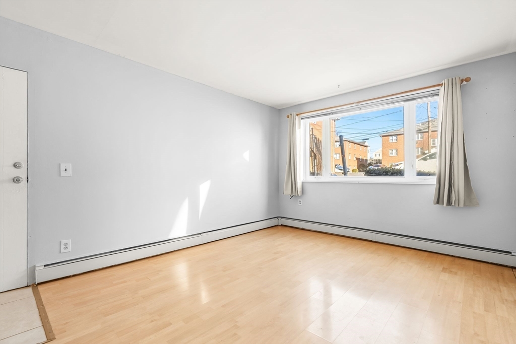 133 Warren Street, Unit 3 Watertown, MA 02472 - Photo 8 of 22 an empty room with a window