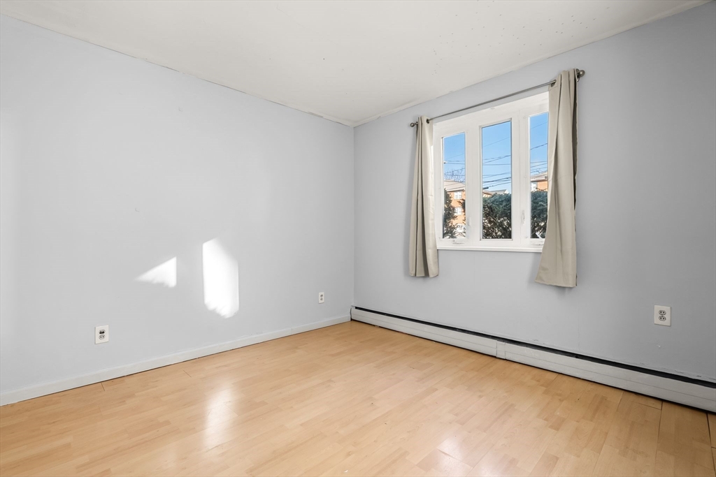 133 Warren Street, Unit 3 Watertown, MA 02472 - Photo 10 of 22 an empty room with a window