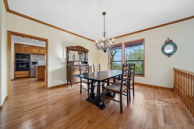 a view of a dining room with furniture wooden floor and chandelier
