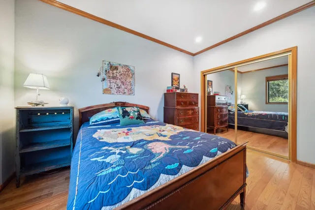 a bedroom with a bed and a dresser