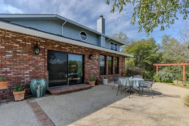 a view of a building with sitting area and furniture