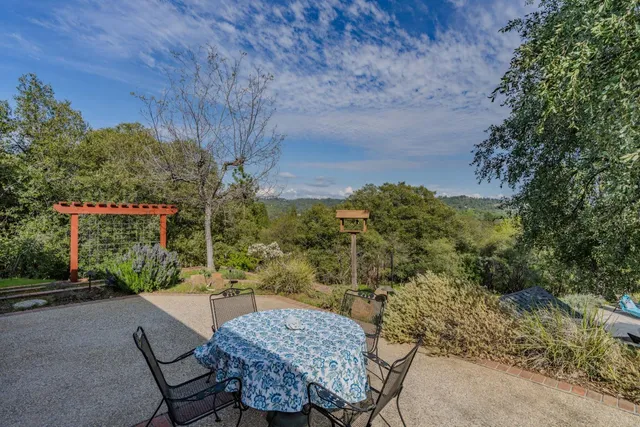 a view of a patio with furniture and a yard