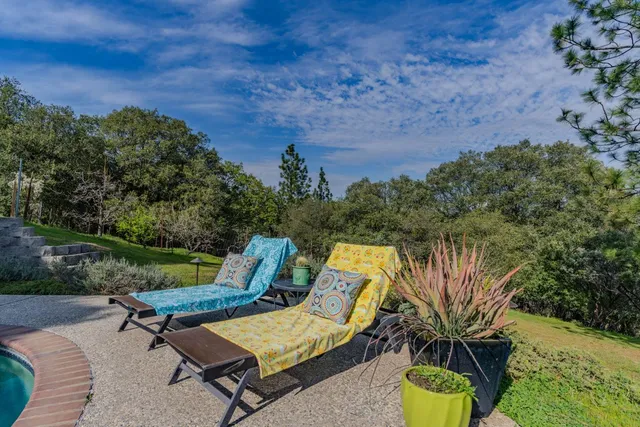 a view of a lounge chair in the backyard of a house