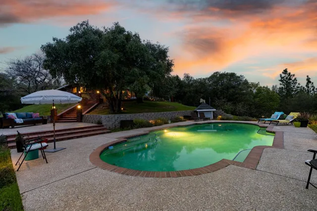 a view of a swimming pool and lounge chair