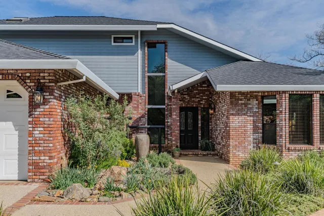 a view of a house with potted plants