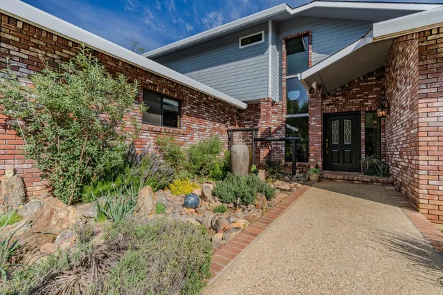 a backyard of a house with yard and outdoor seating