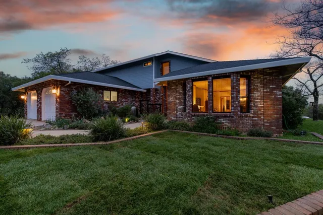 a front view of a house with garden