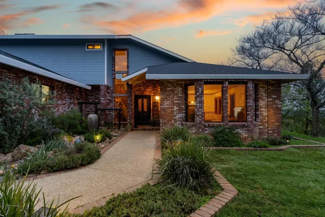 a view of a patio with a table and chairs under an umbrella