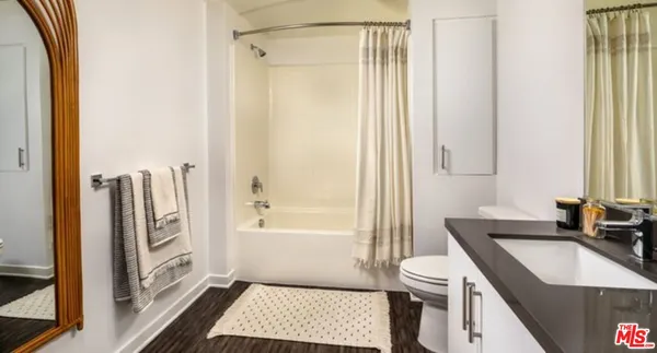 a kitchen with stainless steel appliances a dining table chairs and a refrigerator