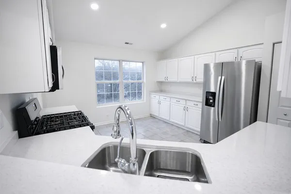a kitchen that has a sink and a stove in it