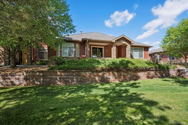 an aerial view of residential house with outdoor space and trees all around