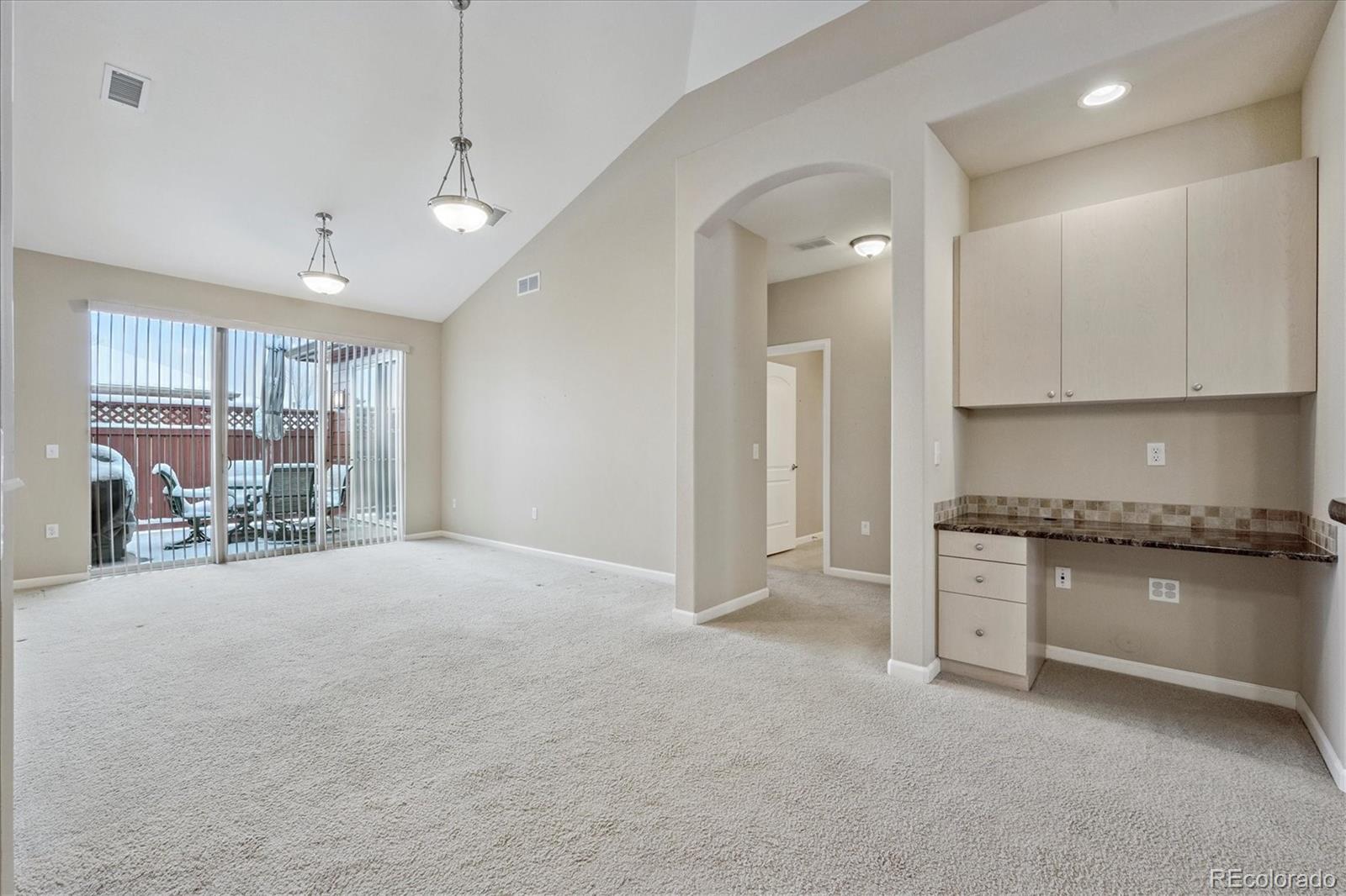 8650 Gold Peak Drive, Unit A Highlands Ranch, CO 80130 - Photo 17 of 47 a view of a kitchen with a stove and a refrigerator