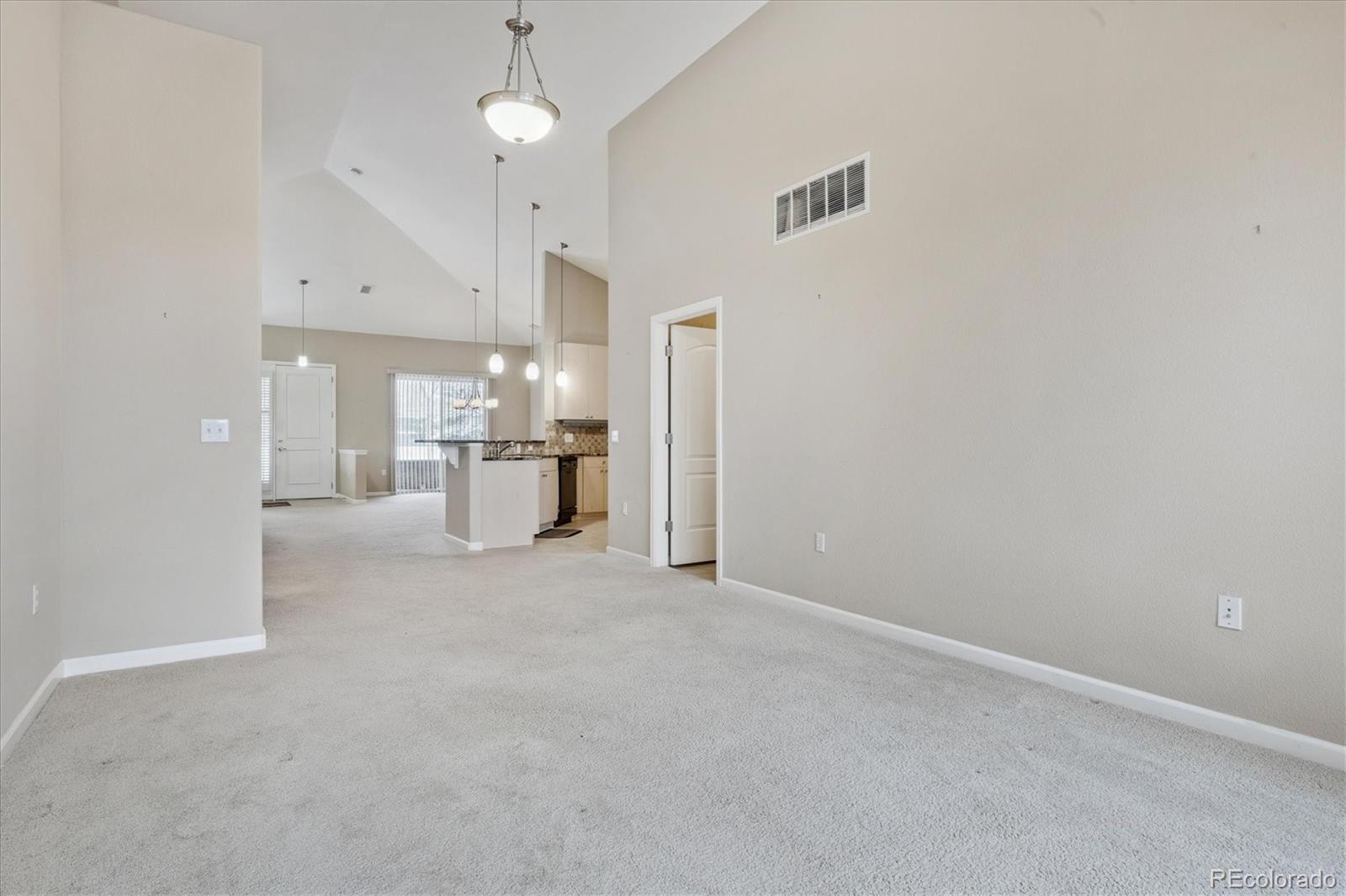 8650 Gold Peak Drive, Unit A Highlands Ranch, CO 80130 - Photo 21 of 47 a view of a kitchen with a sink and refrigerator