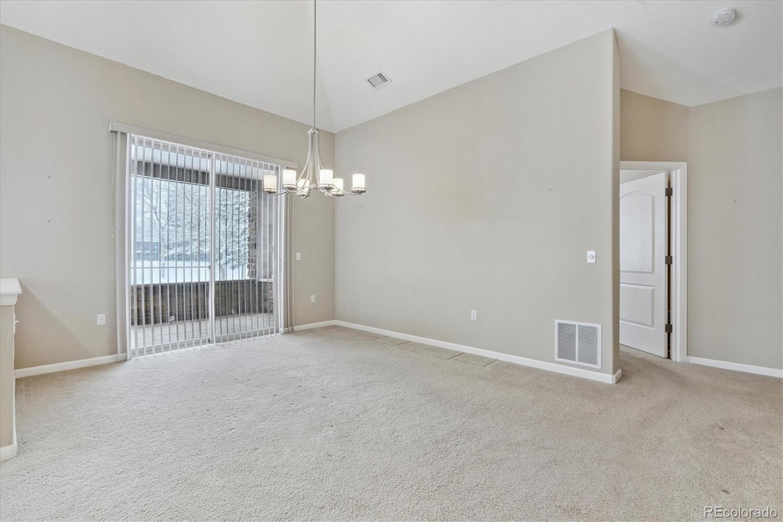 8650 Gold Peak Drive, Unit A Highlands Ranch, CO 80130 - Photo 22 of 47 a view of a big room with chandelier front door