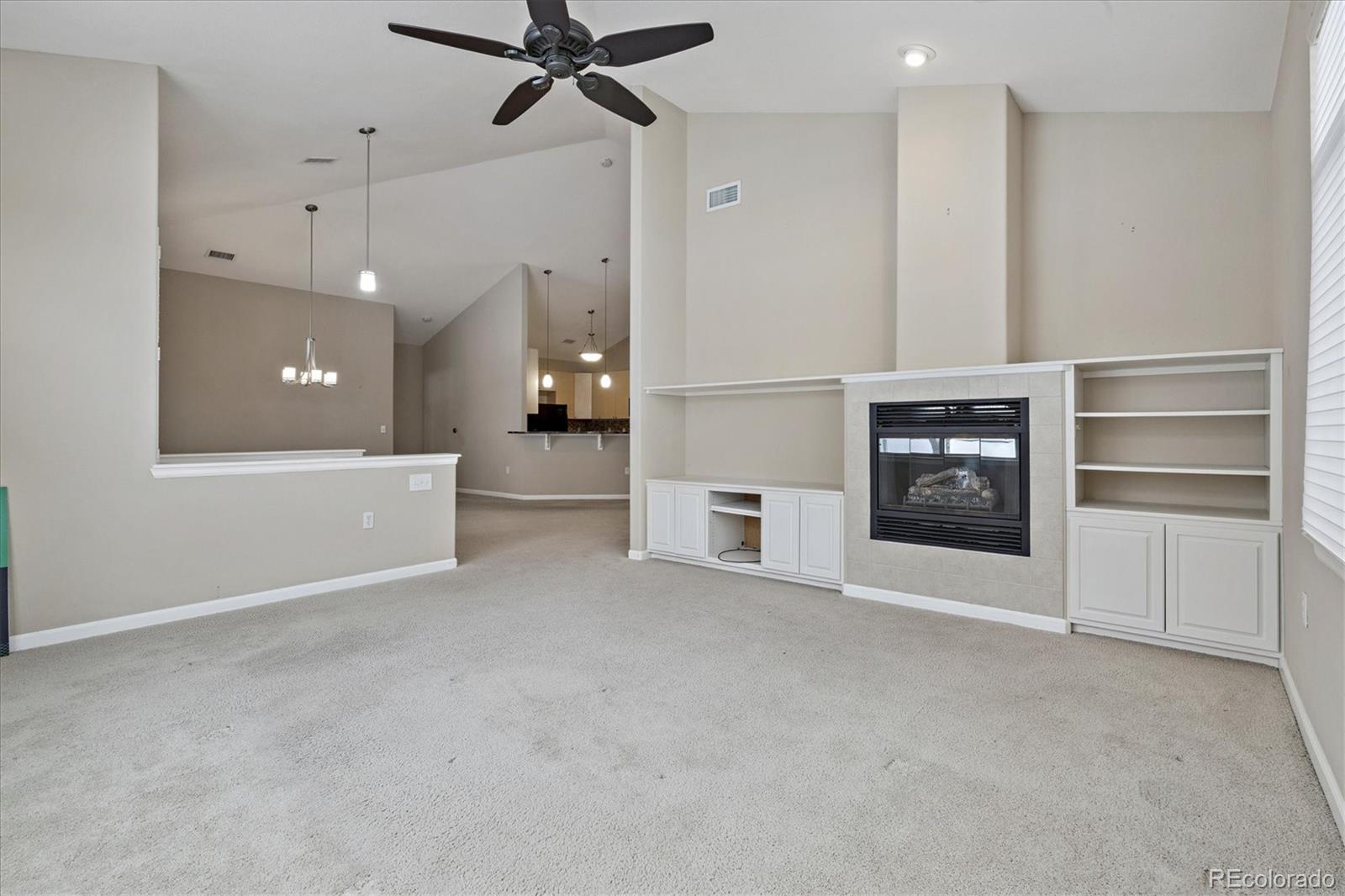 8650 Gold Peak Drive, Unit A Highlands Ranch, CO 80130 - Photo 24 of 47 a view of an empty room with a kitchen