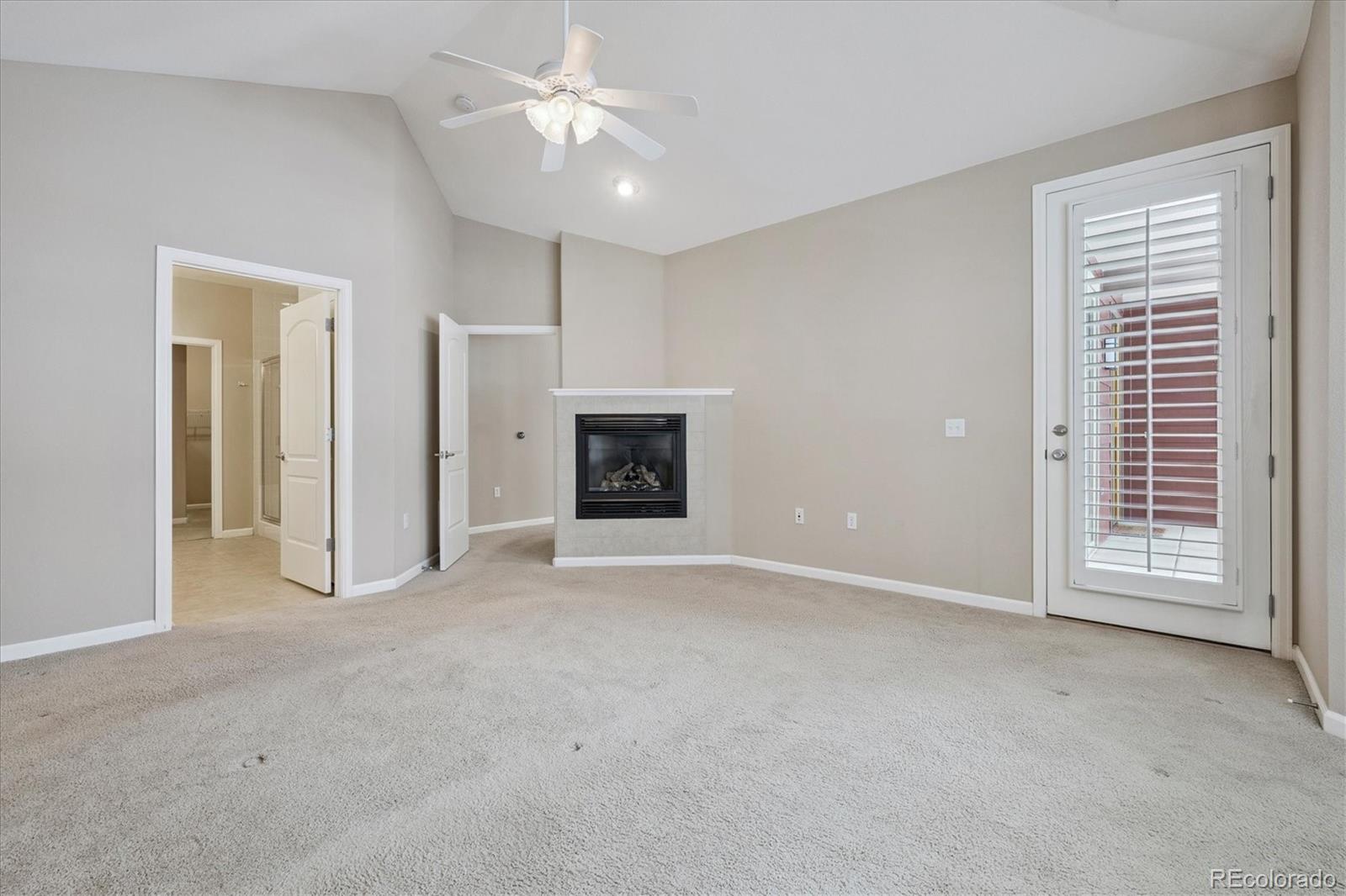 8650 Gold Peak Drive, Unit A Highlands Ranch, CO 80130 - Photo 26 of 47 an empty room with windows and a fireplace