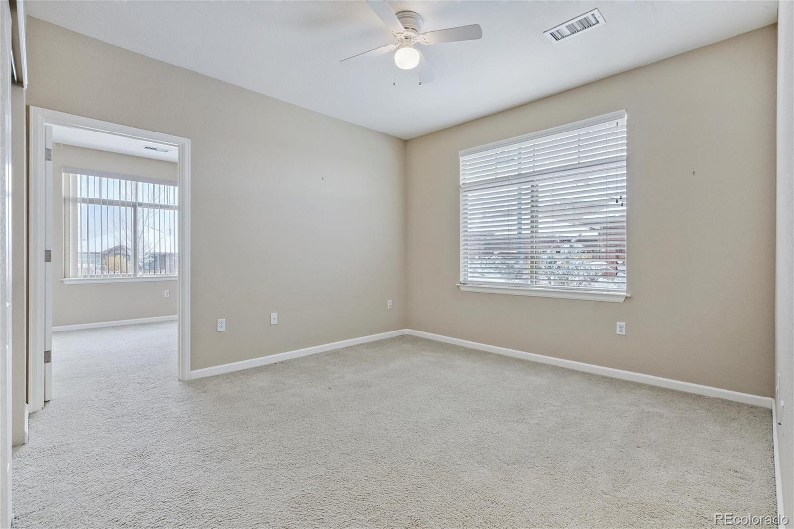 8650 Gold Peak Drive, Unit A Highlands Ranch, CO 80130 - Photo 35 of 47 an empty room with windows and fan