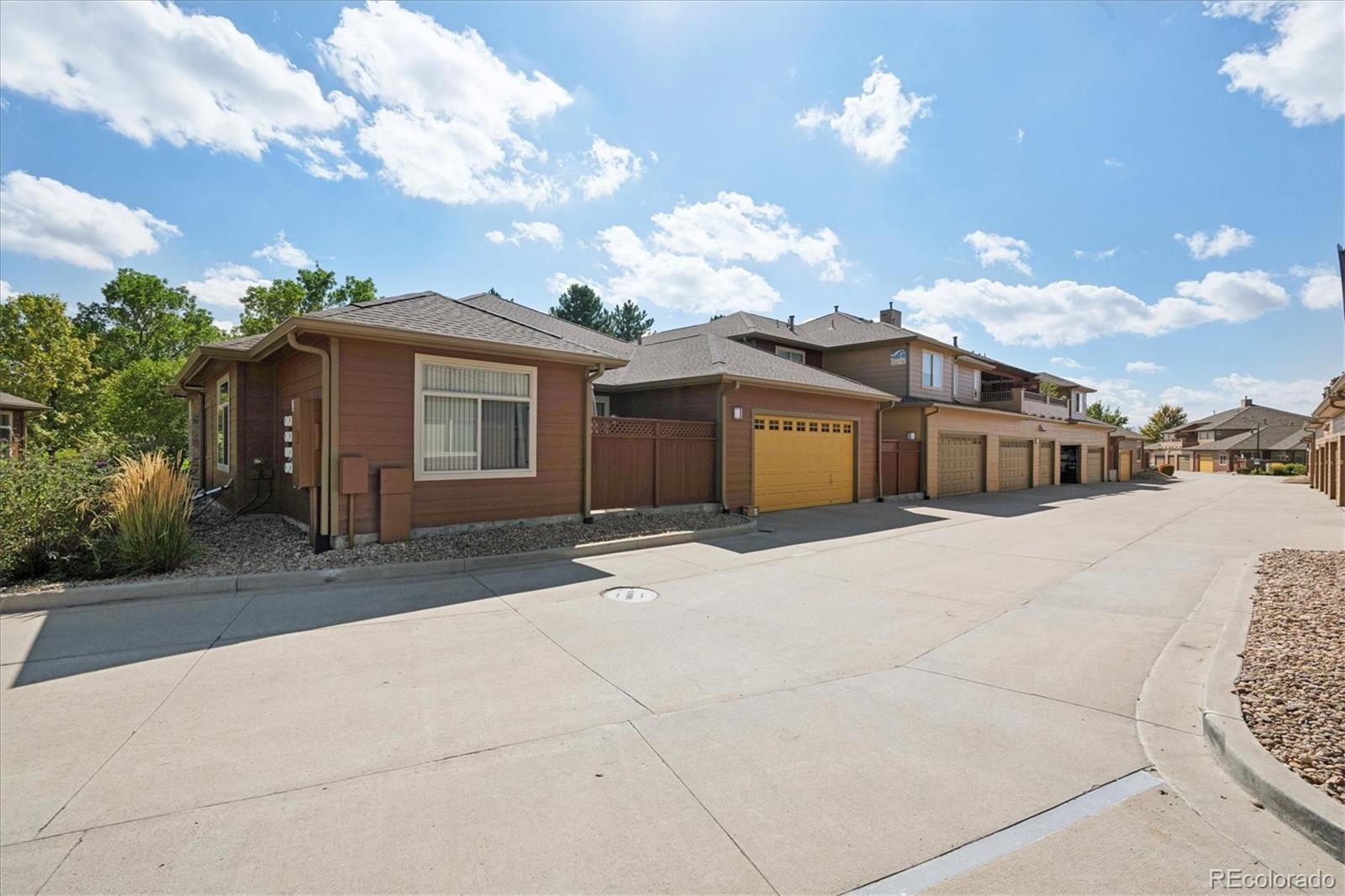 8650 Gold Peak Drive, Unit A Highlands Ranch, CO 80130 - Photo 42 of 47 a view of a house with a yard