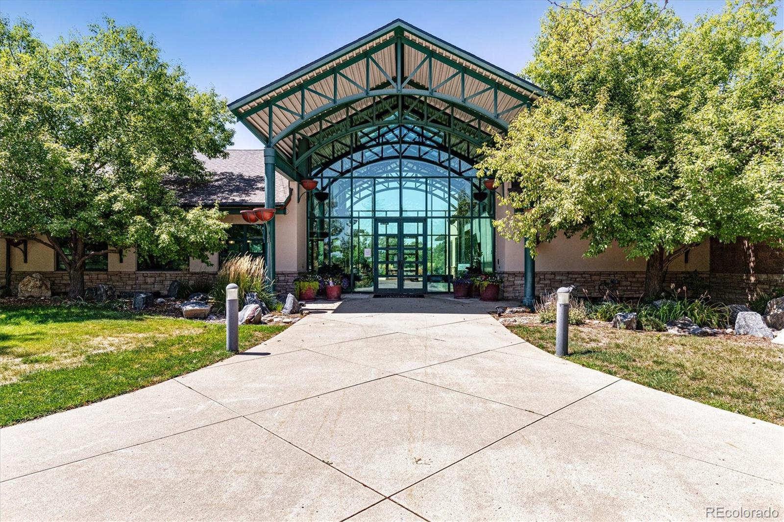 8650 Gold Peak Drive, Unit A Highlands Ranch, CO 80130 - Photo 43 of 47 a front view of a house with a garden