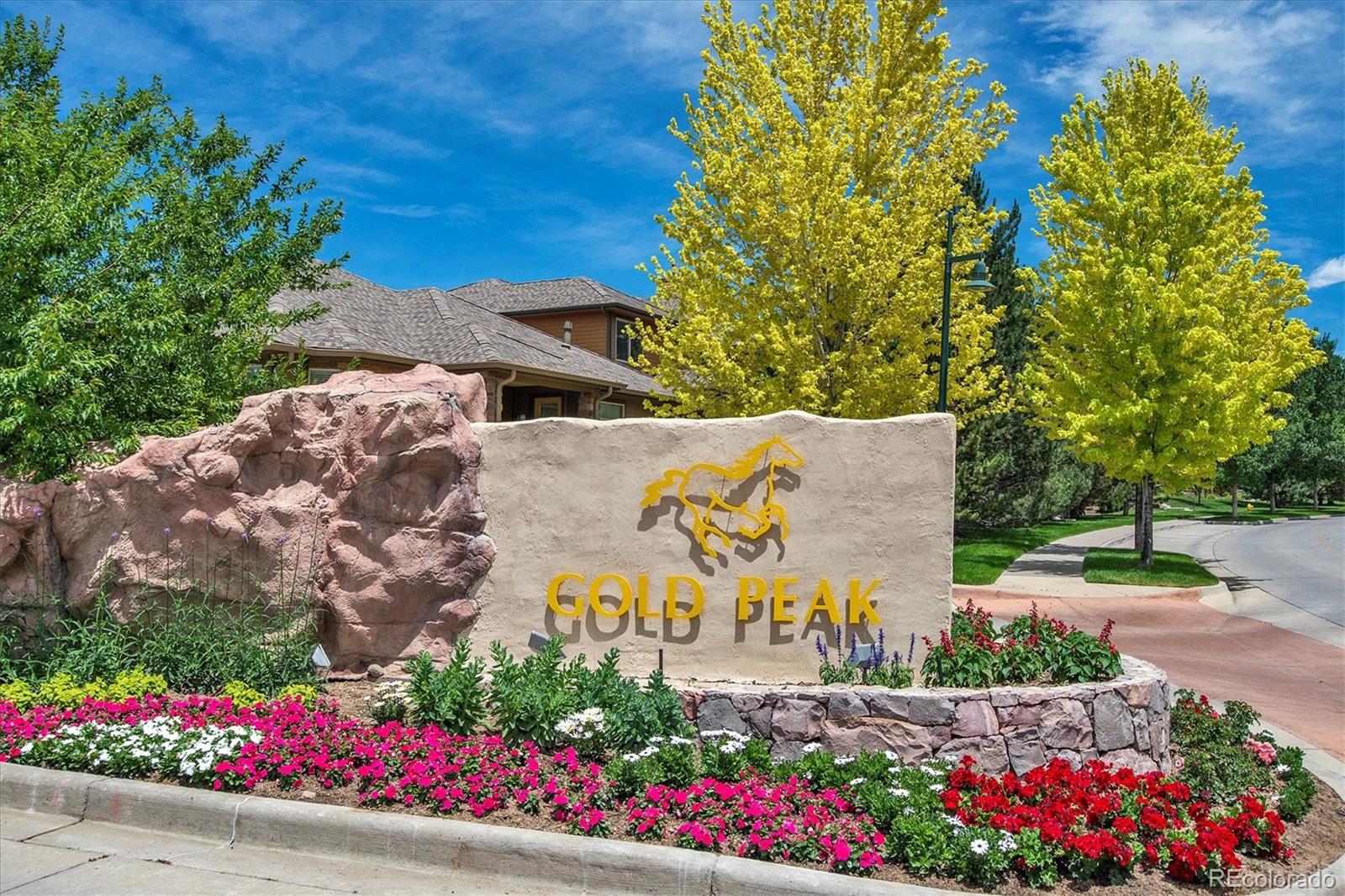 8650 Gold Peak Drive, Unit A Highlands Ranch, CO 80130 - Photo 47 of 47 a view of a sign board with flower plants