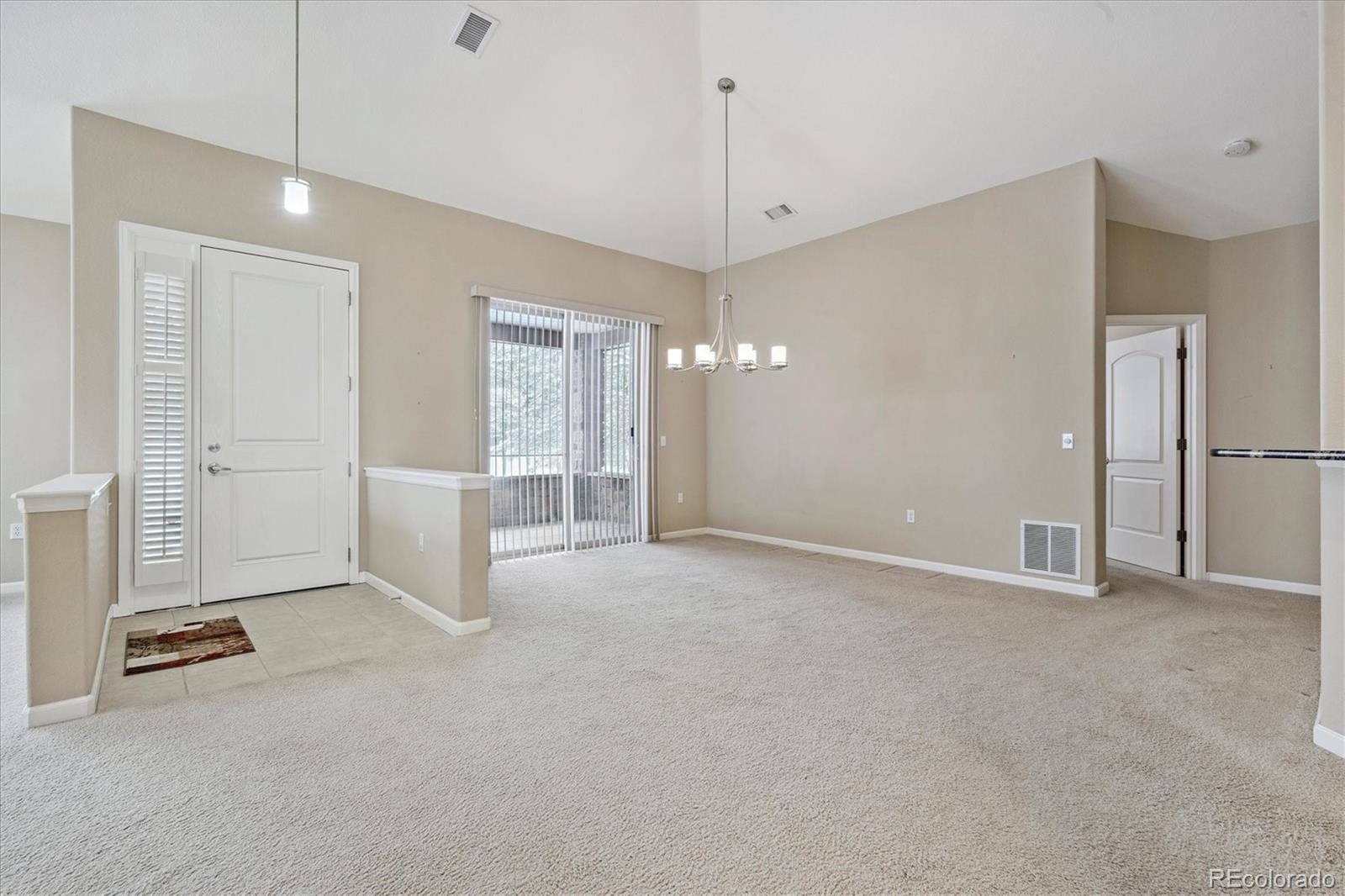 8650 Gold Peak Drive, Unit A Highlands Ranch, CO 80130 - Photo 7 of 47 a view of an empty room with kitchen and a window
