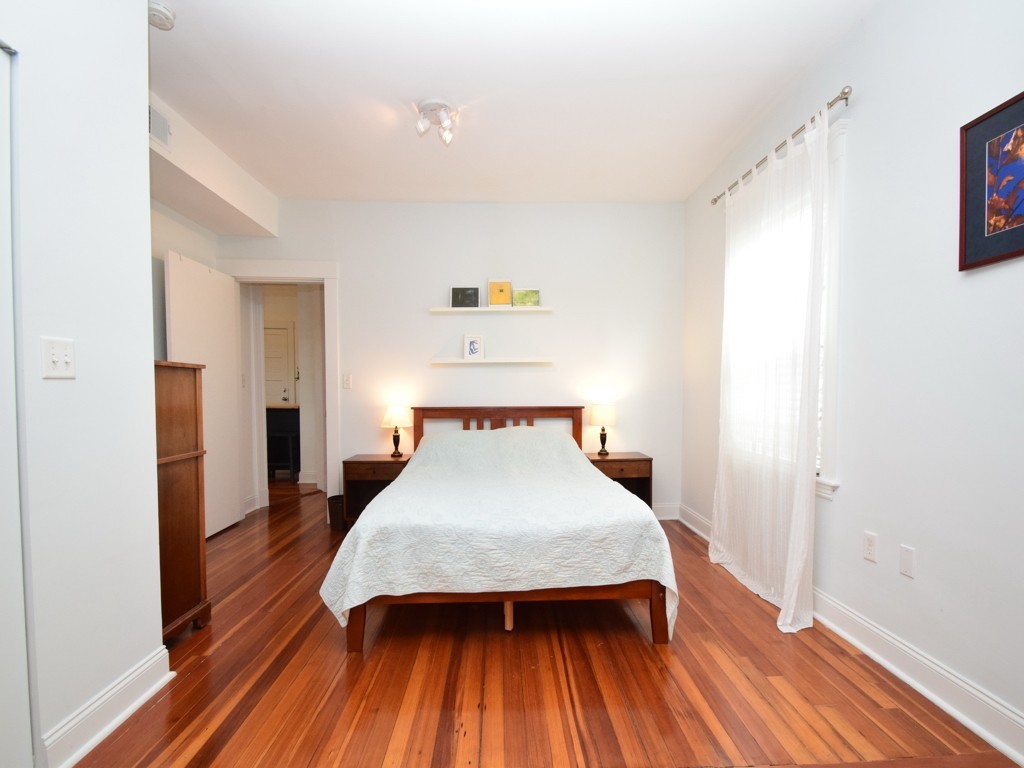 78 Montebello Road, Unit 3 Boston, MA 02130 - Photo 11 of 19 a bedroom with a bed and wooden floor
