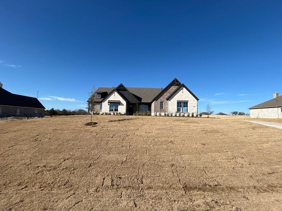 a house view with a wooden fence and trees