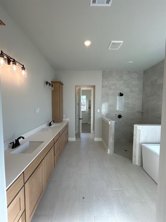 812 Vly Rdg Road Van Alstyne, TX 75495 - Photo 10 of 20 a view of a bathroom with a tub and sink