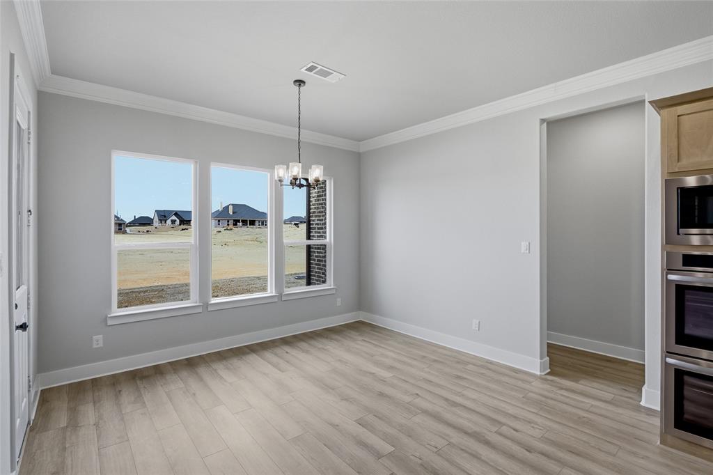 812 Vly Rdg Road Van Alstyne, TX 75495 - Photo 11 of 33 a view of empty room with wooden floor and fan