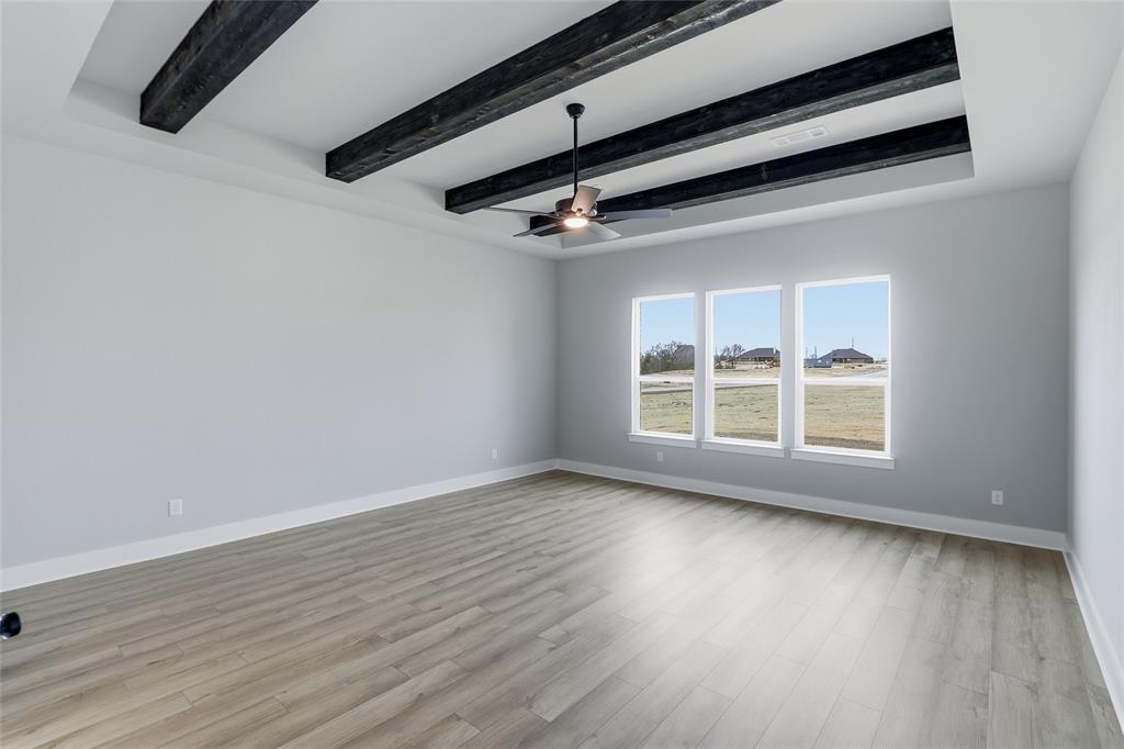 812 Vly Rdg Road Van Alstyne, TX 75495 - Photo 12 of 33 an empty room with wooden floor window and ceiling fan