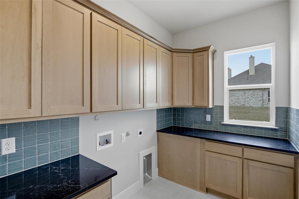 812 Vly Rdg Road Van Alstyne, TX 75495 - Photo 24 of 33 a kitchen with stainless steel appliances granite countertop white cabinets a window and a sink