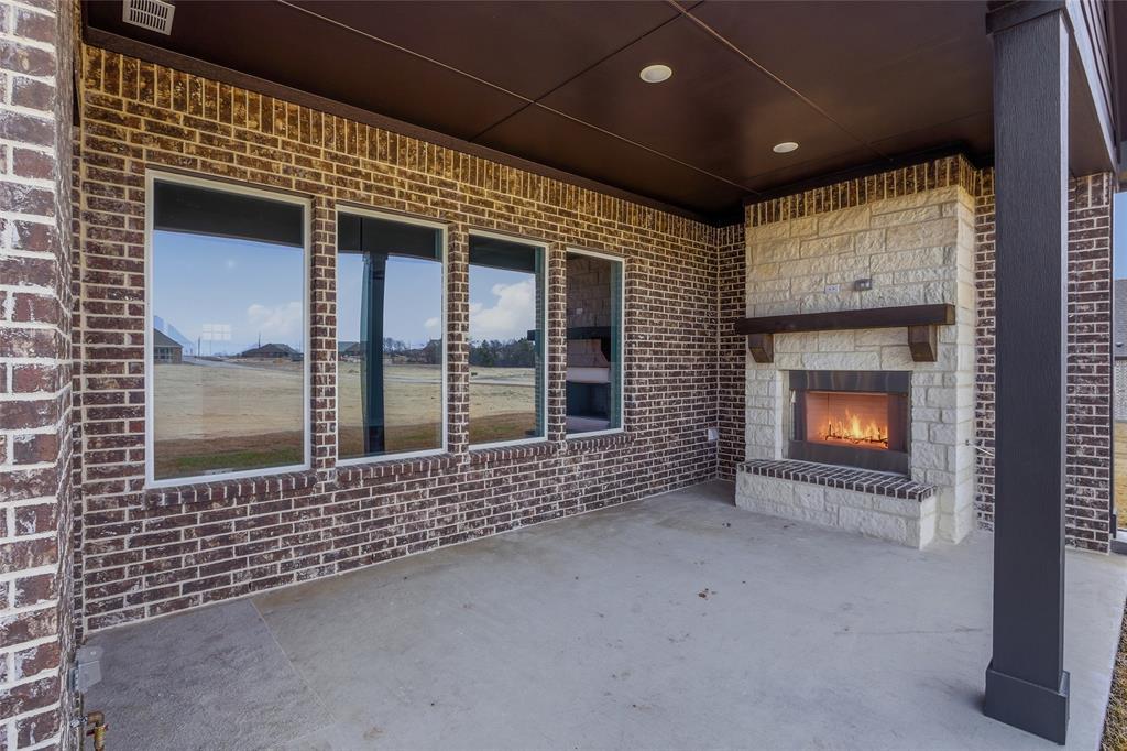 812 Vly Rdg Road Van Alstyne, TX 75495 - Photo 28 of 33 a view of an empty room with a fireplace and a window