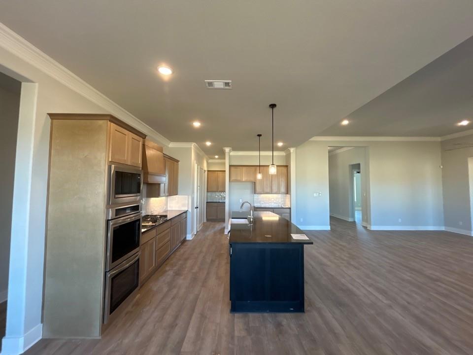 812 Vly Rdg Road Van Alstyne, TX 75495 - Photo 8 of 20 a kitchen with stainless steel appliances kitchen island granite countertop a stove and a refrigerator