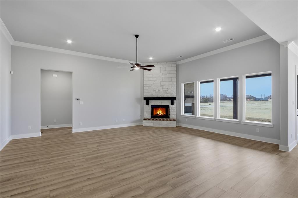 812 Vly Rdg Road Van Alstyne, TX 75495 - Photo 10 of 33 a view of an empty room with wooden floor fireplace and a window