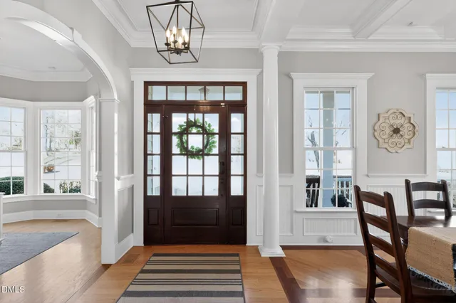 a living room with furniture kitchen view and a potted plant