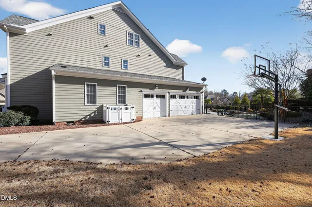 a kitchen with granite countertop a table chairs stainless steel appliances and cabinets