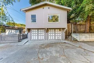 a view of house with backyard and deck