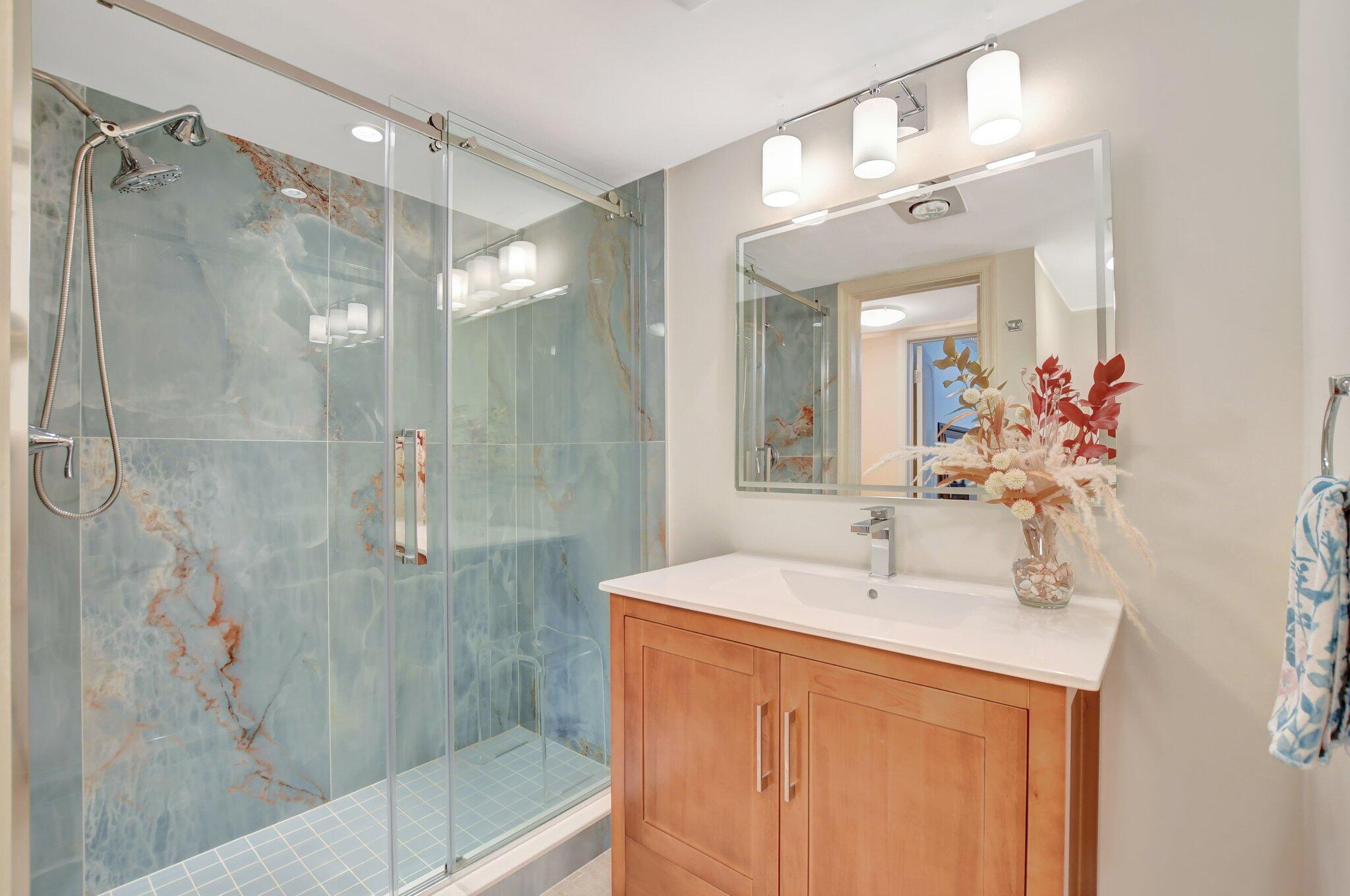 1099 South Ocean Boulevard, Unit 105 Boca Raton, FL 33432 - Photo 15 of 30 a bathroom with a sink and a mirror
