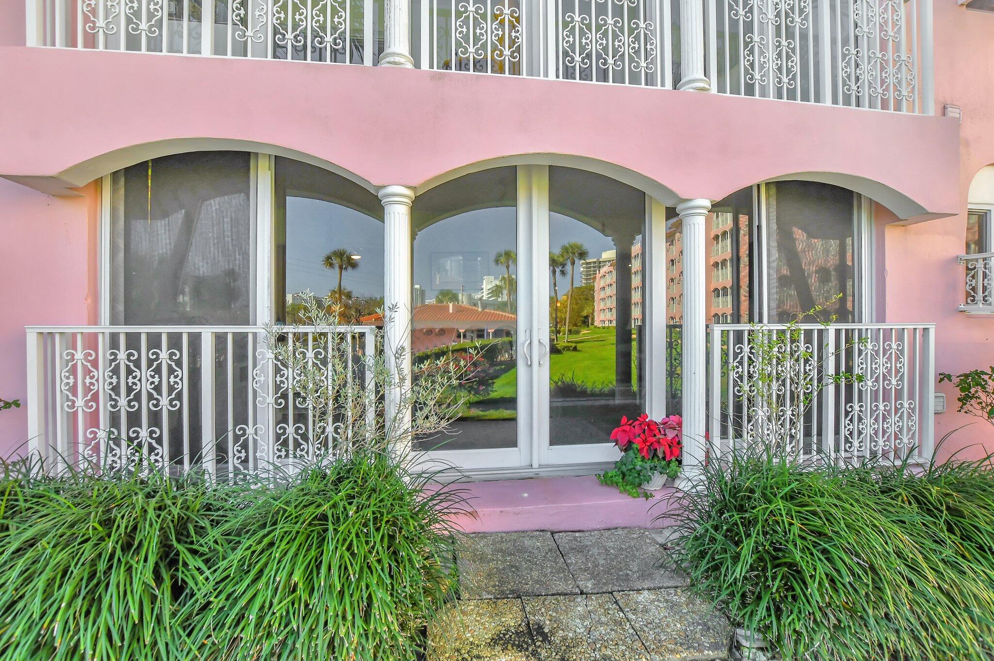 1099 South Ocean Boulevard, Unit 105 Boca Raton, FL 33432 - Photo 19 of 30 a front view of a house with a garden