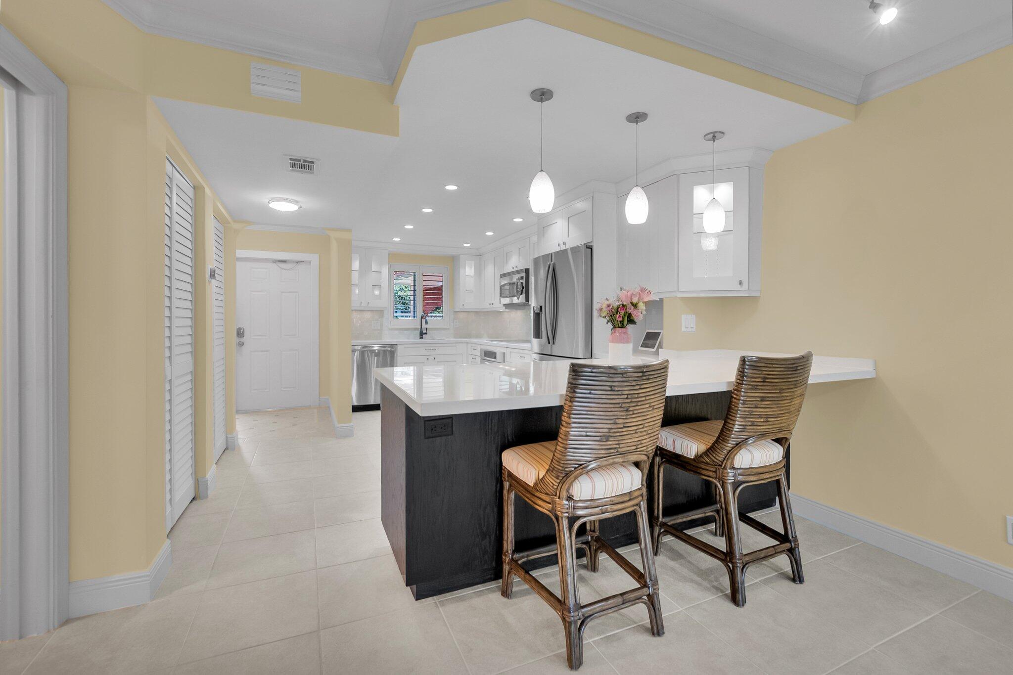1099 South Ocean Boulevard, Unit 105 Boca Raton, FL 33432 - Photo 7 of 30 a kitchen with a table and chairs in it