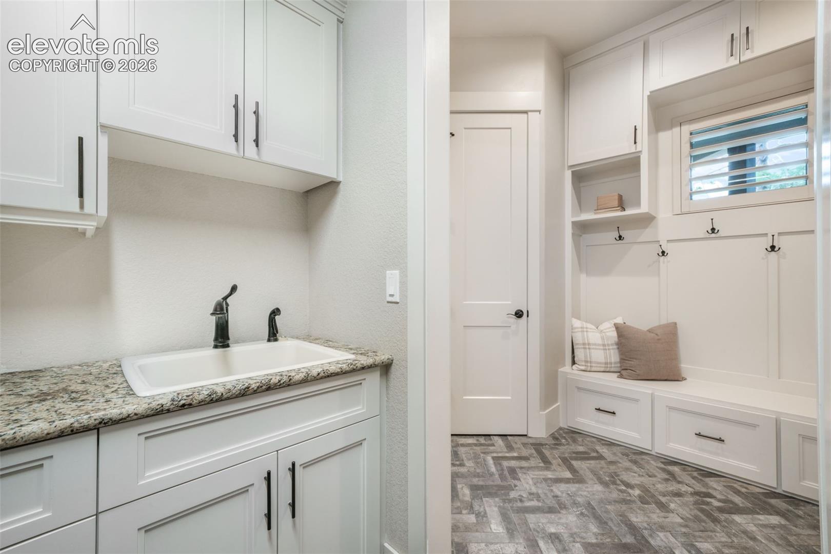 18572 Wetherill Road Monument, CO 80132 - Photo 15 of 50 Stackable washer and dryer, lots of storage, and a utility sink.