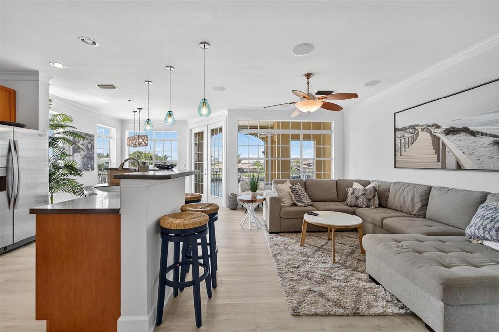 6428 Sunset Bay Circle Apollo Beach, FL 33572 - Photo 16 of 90 a living room with furniture a flat screen tv and kitchen view